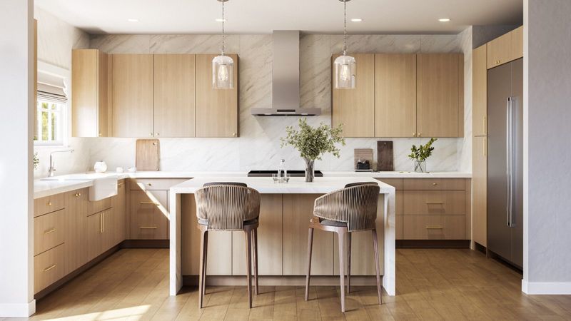 Modern white oak slab-door kitchen with waterfall island